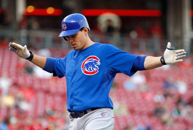 Chicago Cubs' Bryan LaHair claps his hands at home plate after hitting a solo home run off Cincinnati Reds pitcher Bronson Arroyo during the second inning of a baseball game Wednesday, May 2, 2012, in Cincinnati.