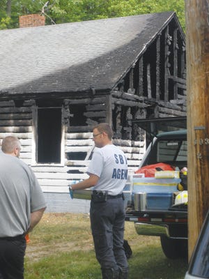 Investigators with the Lexington Fire Department, State Bureau of Investigation, Lexington Police Department and Davidson County Fire Marshal's Office investigate a suspicious fire that caused heavy damage to a home at 10 Lopp St. early Friday morning.