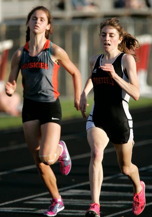 Harlem's Leah Raffety (left) and Freeport's Ellie Willging race to the finish in the 3,200-meter run at the NIC-10 girls conference championship meet Thursday, May 3, 2012, at Boylan High School in Rockford.