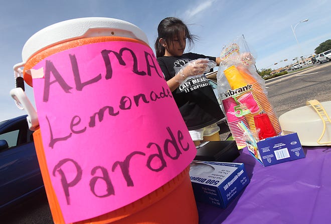 Alma Santiago tends to her lemonade stand on Saturday morning at 50th and Utica in Lubbock. Santiago was participating in Lemonade Day Lubbock. Alma is donating all her proceeds to the Salvation Army.