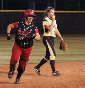 Central Davidson’s Jack Byrd (left) smiles as she rounds the bases past East Davidson shortstop Morgan Gallimore after hitting a three-run home run in the fifth inning against East Davidson on Friday night during the Central Carolina Conference Tournament championship game.