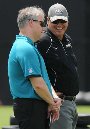 Bob.Mack@jacksonville.com Jaguars general manager Gene Smith talks with Jacksonville University coach Kerwin Bell, who came out to watch minicamp, especially his former quarterback Josh McGregor.