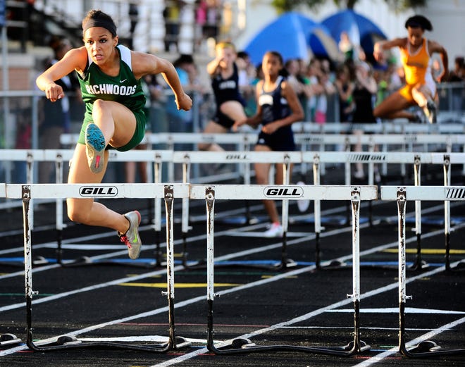 Richwoods high school Junior, Brenna Detra, jumps over the last hurdle to place first in the girls 100 meter hurdle event at the Mid-State 6 Girls track and Field meet held Friday at Peoria Stadium.