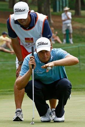 Nick Watney and his caddy line up a putt on the 16th green during the second 
round of the Wells Fargo Championship golf tournament at Quail Hollow Club, 
Friday in Charlotte, N.C. ASSOCIATED PRESS