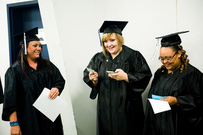 From right, Regina Tavarez, Janette Berry and Heather Ames await the start of their graduation ceremony Saturday at Columbia College.