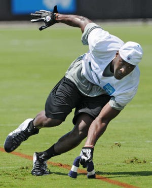 Bob.Mack@jacksonville.com First-round draft pick Justin Blackmon scoops up a towel during an agility drill at the Jaguars rookie minicamp on Saturday. Blackmon didn't work out Sunday, the final day of the minicamp, because of a sore foot.