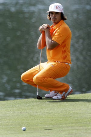 Rickie Fowler reacts after missing a birdie putt on the 14th hole during the final round of the Wells Fargo Championship golf tournament at Quail Hollow Club in Charlotte, N.C., Sunday. Fowler won the tournament on the first playoff hole. (AP Photo/Chuck Burton)