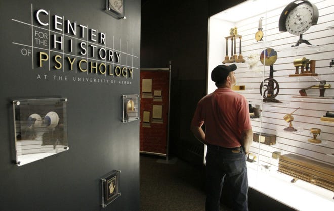 Scott Denny of Alliance looks at some of the Psychology collection, during the opening reception for the display Connecting Objects to their People: From the Artic to Arizona at the University of Akron Center for the History of Psychology on Sunday in Akron, Ohio. (Paul Tople/Akron Beacon Journal)