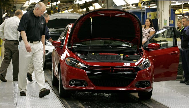 Plant Manager Kurt Kavajecz looks over a Dodge Dart, one of the first driven off the assembly line, during a celebration at the Belvidere Assembly Plant on Monday, May 7, 2012.