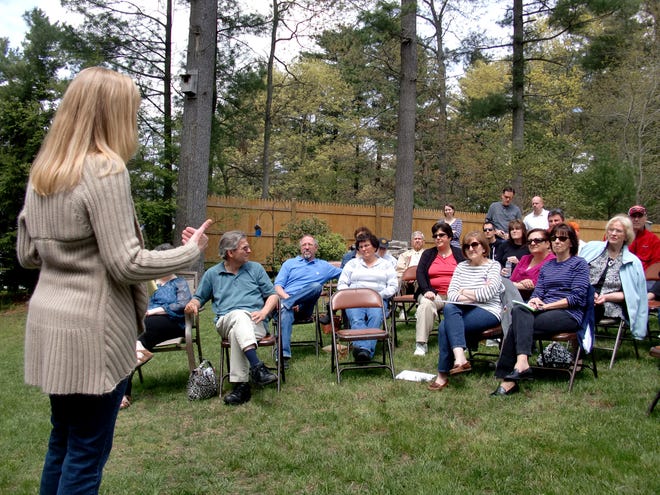 Michelle Littlefield, left, speaks in her backyard on Sunday to a group of East Taunton residents who are organizing against a tribal casino that has been proposed for the city. The Mashpee Wampanoag Tribe hopes to build the casino in the Liberty and Union Industrial Park.