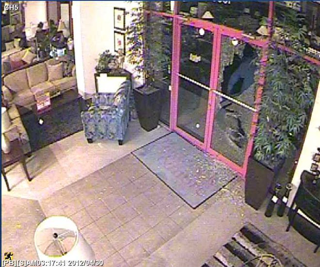 Security camera video shows a man in a hooded sweatshirt inside the Badcock Furniture store at 10965 Beach Blvd.