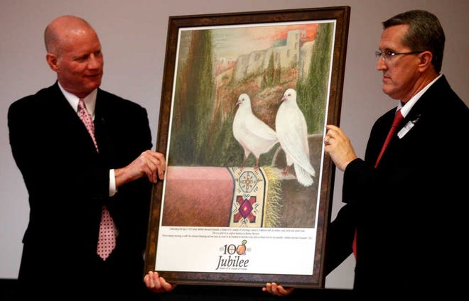 Covenant Health System CEO Richard Parks, left, and Covenant Vice President Steve Bec, hold a print drawn by Mother Bernard Gosselin, a sister of St. Joseph of LaGrange in 1912, during a ceremony celebrating the Sisters of St. Joseph of Orange at Covenant Women's and Children's Hospital. A print will hang in the lobby of the hospital.