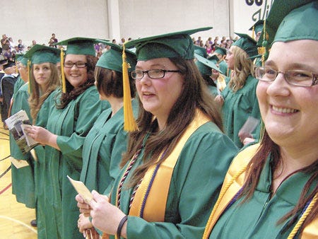 About two-thirds of Glen Oaks Community College’s class of 2012 took part in Friday’s graduation ceremony at the school’s gymnasium. Among the 150 participants were Bethany Armstrong, far right, of White Pigeon, and Sasha Cowan, of Constantine.