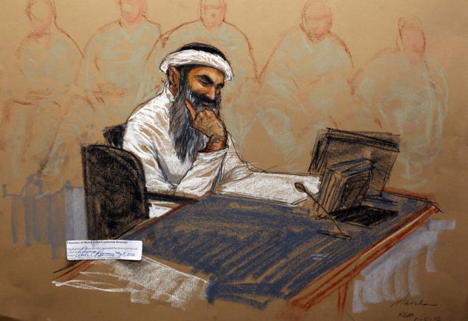 In this photo of a sketch by courtroom artist Janet Hamlin and reviewed by the U.S. Department of Defense, Khalid Sheikh Mohammed reads a document during his military hearing at the Guantanamo Bay U.S. Naval Base in Cuba, Saturday, May 5, 2012. The self-proclaimed mastermind of the Sept. 11 attacks, Khalid Sheikh Mohammed repeatedly declined to respond to a judge's questions Saturday and his co-defendant Walid bin Attash was briefly restrained at a military hearing as five men charged with the worst terror attack in U.S. history appeared in public for the first time in more than three years. (AP Photo/Janet Hamlin, Pool)