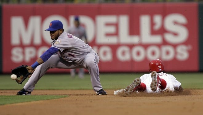 Philadelphia's Juan Pierre beats the throw to New York's Jordany Valdespin at second base in the first inning Tuesday.
