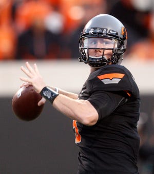 Oklahoma State quarterback Brandon Weeden warms up before the start of an NCAA college football game against Kansas State in Stillwater, Okla., Saturday, Nov. 5, 2011.