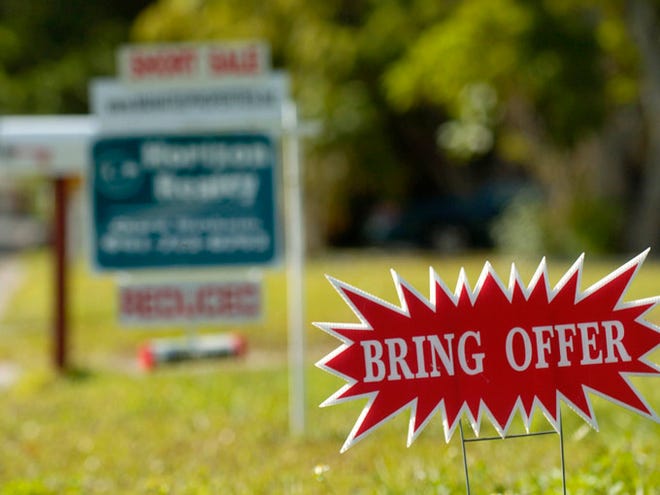 A sign for a short sale on Novus Street in Sarasota asks potential buyers to bring an offer.