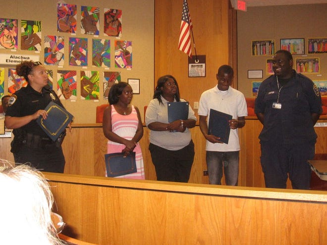 Four students in the Gainesville Police Explorers Post 917 were recognized at the monthly meeting of the Black on Black Crime Task Force. They are, from left, with GPD officer Dontonya Smith, T’quavia Lewis, Crystal McBride, Javarre Turner and Jamall Carter.