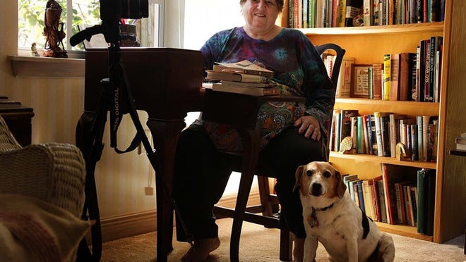 Marth McMullen, author of "Driving Woodie: Tales From The Home Front in World War II," poses with Xanda, her 13-year-old beagle and Jack Russell terrier mix.