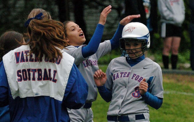 Kate Haff’s Waterford teammates congratulate her Wednesday after she hit a two-run homer during the Lancers’ 17-0, five-inning win over Woodstock Academy in Woodstock.