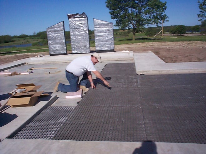 Jerry Ellis does some volunteer work in preparation for brick pavers to be laid at the Canton Veterans Memorial being built at Lakeland Park. He is adjusting grading tables to ensure the bricks lie flat.