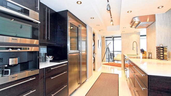 George Hamilton’s galley-style kitchen is furnished with European appliances, including a Miele coffee system.