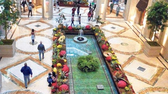 The carefully tended garden with live flowers and tropical plants and a two-story waterfall backdrop serve as one of the Palazzo/Venetian’s cavernous entrances.