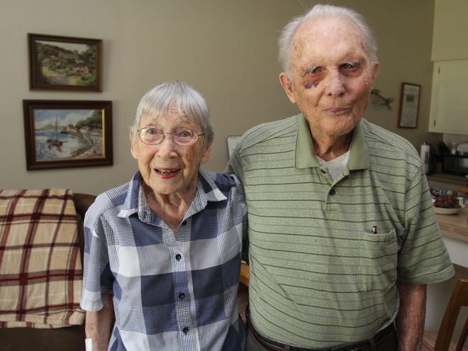 Main photo caption: John Seay, 98, right, and his wife, Mary, 95, pose together for a photo in their apartment at Chambrel at Pinecastle in Ocala on Thursday. The couple has been married for 72 years.