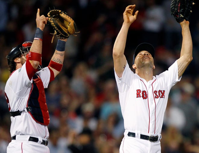 Boston Red Sox closer Alfredo Aceves, right, and catcher Jarrod Saltalamacchia celebrate after defeating the Cleveland Indians 4-1 in a baseball game in Boston, Saturday, May 12, 2012. (AP Photo/Michael Dwyer)