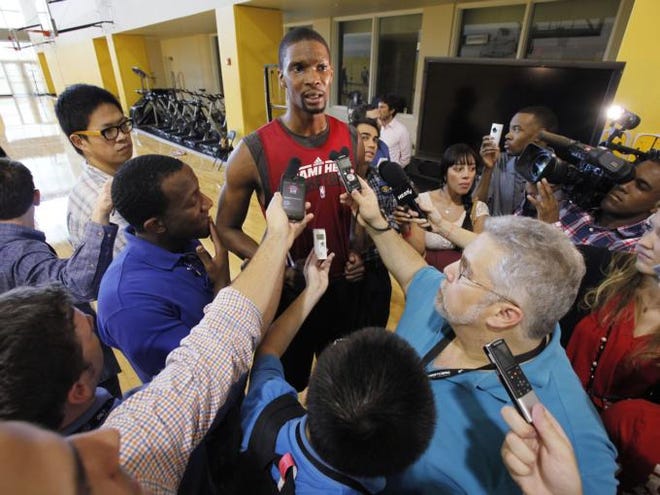 Miami Heat's Chris Bosh is surrounded by members of the media as he speaks after a team practice, Saturday, May 12, 2012 in Miami.