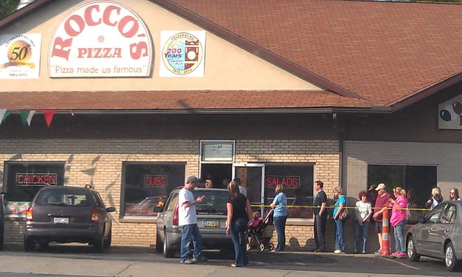 Rocco's Pizza celebrates 50 years at the Portage Trail location by selling plain and pepperoni pizzas for the 1962 price of 1.95 and 2.25 Monday from 4-10 pm.
By 5:30, nearly 100 people were standing in line. (Gina Mace/Ohio.com)
