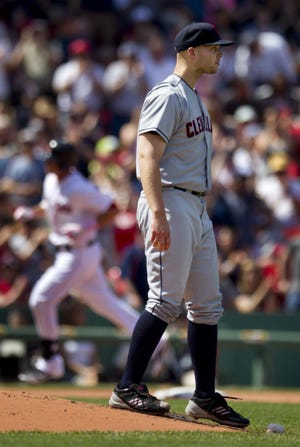 Cleveland Indians' Justin Masterson (right) looks on as Boston Red Sox's Will Middlebrooks, left, rounds the bases toward home after hitting a home run off a pitch by Masterson in the third inning of a game at Fenway Park in Boston, SundaY. (AP Photo/Steven Senne)