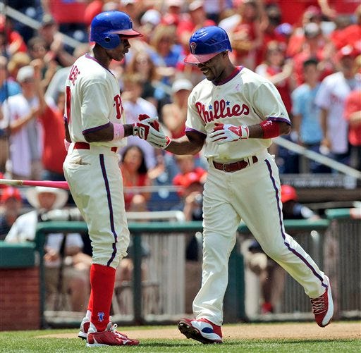 Philadelphia Phillies Juan Pierre, left, greets Jimmy Rollins, right, at home plate after Rollins hit a home run against the San Diego Padres during a baseball game, Sunday, May 13, 2012, in Philadelphia. The Phillies won 3-2. (AP Photo/The Express-Times, Matt Smith)