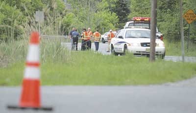 Photo by Daniel Freel/New Jersey Herald - Hardyston police and New Jersey Department of Transportation workers assess the scene of an accident between a motorcycle and a car on Route 94 in Hardyston.