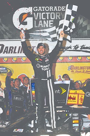 Jimmie Johnson celebrates his win in Victory Lane during the NASCAR Sprint Cup Series auto race at Darlington Raceway, Saturday, May 12, 2012, in Darlington, SC.