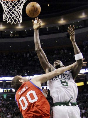 The Celtics' Kevin Garnett, right, draws contact from the 76ers' Spencer Hawes during the fourth quarter of Game 1 Saturday.