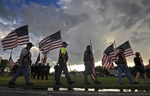 Members of the Patriot Guard Riders stand by as family members enter the Keystone Heights High School football field on Monday evening during the memorial service for Army Staff Sgt. Dick Alson Lee Jr., who died last month from injuries suffered in Afghanistan.