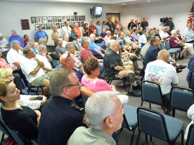 Crowd gathers at St. Augustine Beach City Hall for a special meeting of the
City Commission, which decided to name an interim chief after a majority of
the members of the police force objected to the rule of Chief Richard
Hedges.