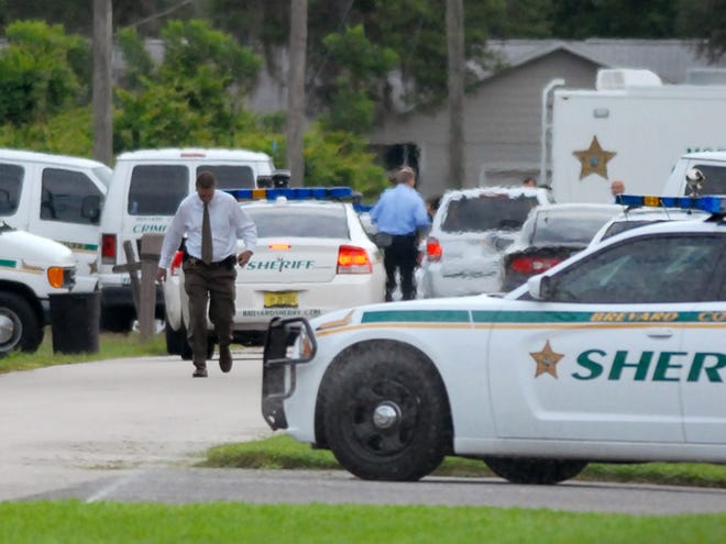 Emergency personell surround the scene of a multiple shooting in Port St. John, Brevard County, Tuesday. Sheriff's deputies in Brevard County said 33-year-old Tanya Thomas on Tuesday shot her four children, who ranged in age from 12 to 17, before shooting herself.  (AP Photo/Florida Today,Tim Shortt)