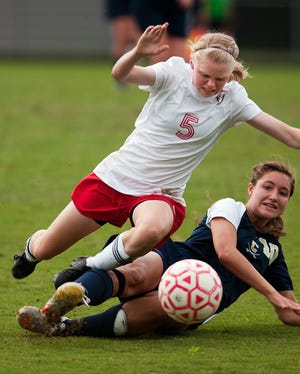 Central Davidson's Haley Westervelt (left) trips over the leg of Cuthbertson's Cardyn Hall on a play early in their state 2-A playoff soccer match Wednesday night.
