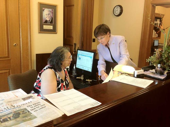 Sen. Laura Kelly, D-Topeka, explains the public employee pension reform plan on its way to the House and Senate to Carolyn Campbell, the administrative assistant to Sen. Anthony Hensley, D-Topeka.