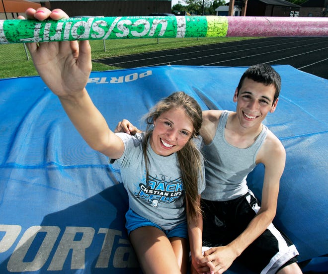 Abby Compton, 16, and Justin Christiansen, 18, sit on the pad in the high jump pit Tuesday, May 15, 2012, at Christian Life High School in Rockford. The couple met through high jumping and both compete for the school.