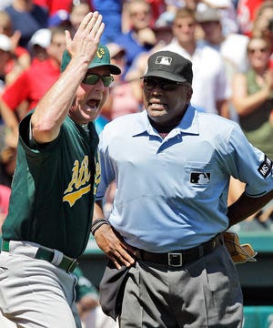 Oakland Athletics manager Bob Melvin, left, argues with home plate umpire Laz Diaz about a call on a bunt by the Texas Rangers' Elvis Andrus during the sixth inning Thursday in Arlington. The Athletics won, 5-4.