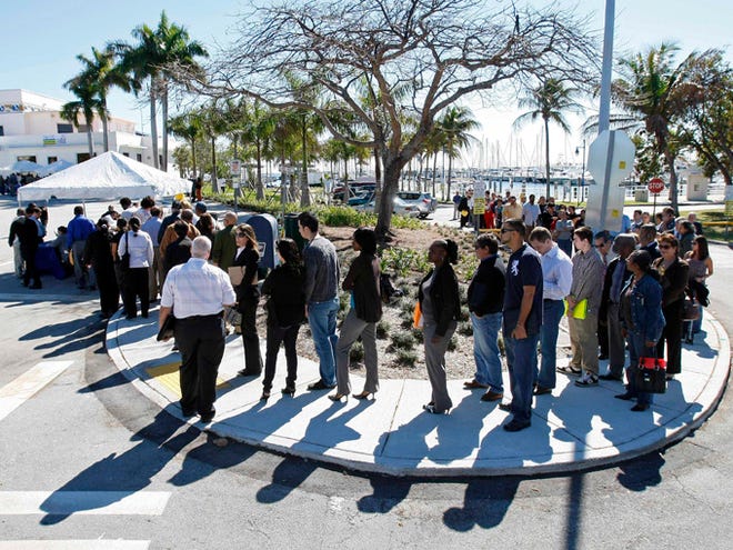 Job seekers line up to register at a City of Miami job fair in Miami, Tuesday, Jan. 26, 2010. On Friday, Florida's seasonally adjusted unemployment rate fell from 9 percent in March to 8.7 percent in April.

 (Associated Press archive / 2010)