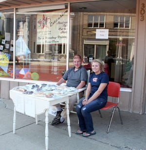 Josh Rowley (left) and Danielle Fuller staff the bake sale table in front of the Creative Works shop and Sozo's Extension.