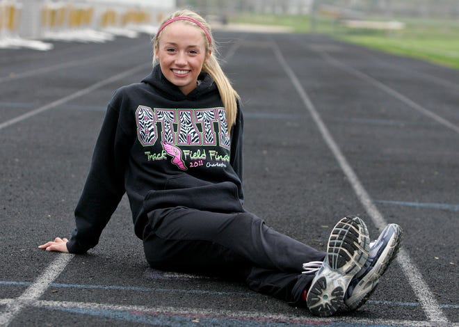 Courtney Clayton, who will compete in the 200, 400 and 800 this season, sits Friday, March 30, 2012, on the track at Hononegah High School before the start of track practice.