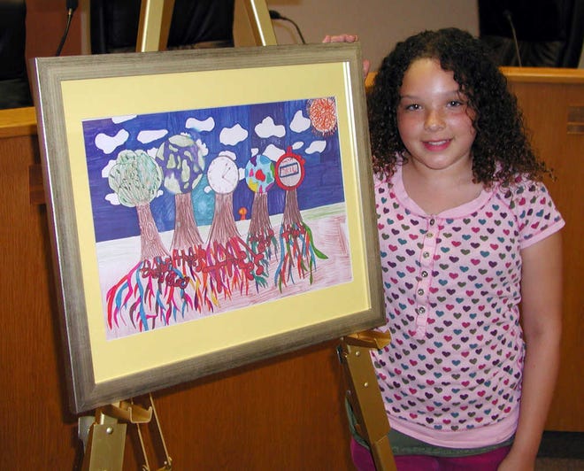 Poster Contest winner Alyvia Ryane Goe is shown with her winning entry that will find a permanent place on a wall in City Hall at the Beach. Photos by FRED WHITLEY, fred.whitley@staugustine.com