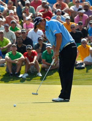 Jason Dufner sinks a 25-foot putt on the 18th green Sunday to win the Byron Nelson Championship in Irving.