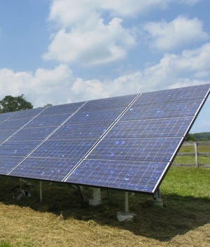 (File photo) A solar panel array in a field behind a farmhouse in Southampton in 2008. (BCT Staff Photograph/Dennis Mc Donald)