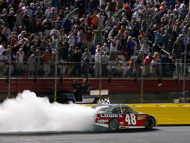 Jimmie Johnson does a burnout after winning the Sprint All-Star race on Saturday night at Charlotte Motor Speedway in Concord, N.C.